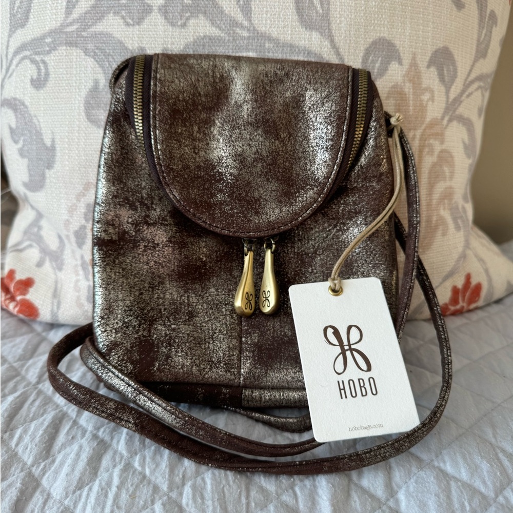 HOBO Fern adjustable compact crossbody bag in brown/gold metallic.